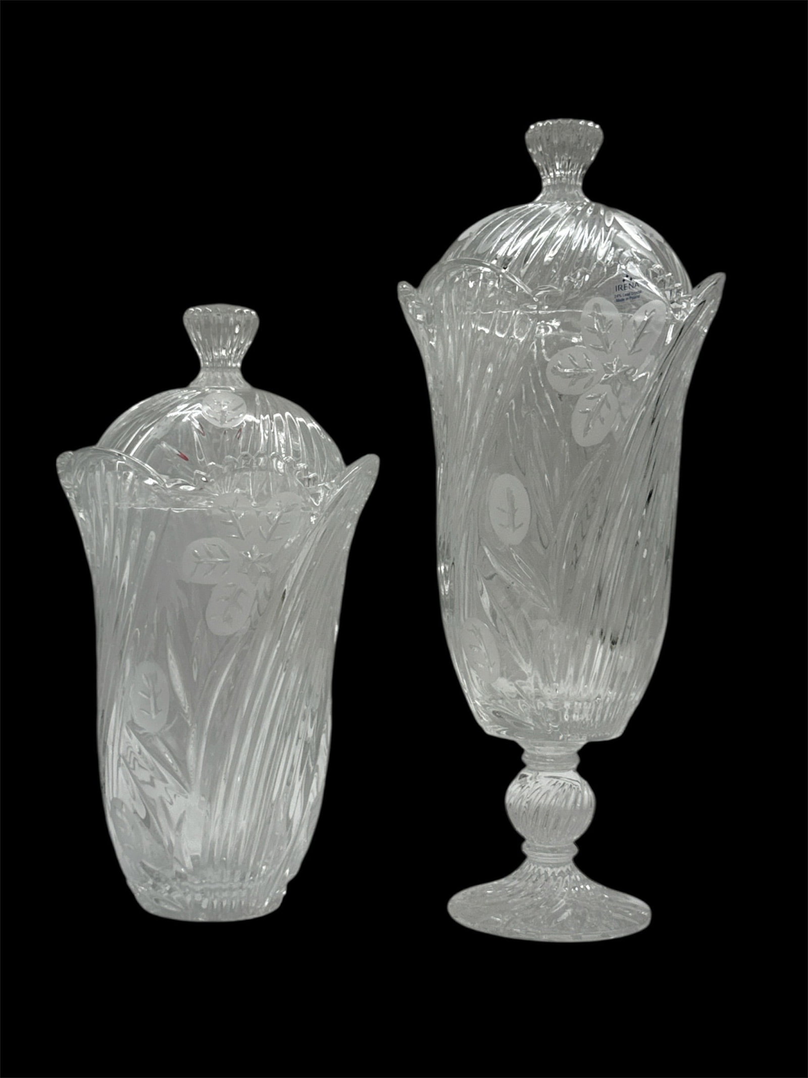 Pair of Tall Etched Crystal Lidded Urns with Floral Motif: Elegant pair of tall etched crystal urns featuring graceful flared rims, pedestal bases, and matching domed lids with faceted finials. Each piece is decorated with finely etched floral and foliate