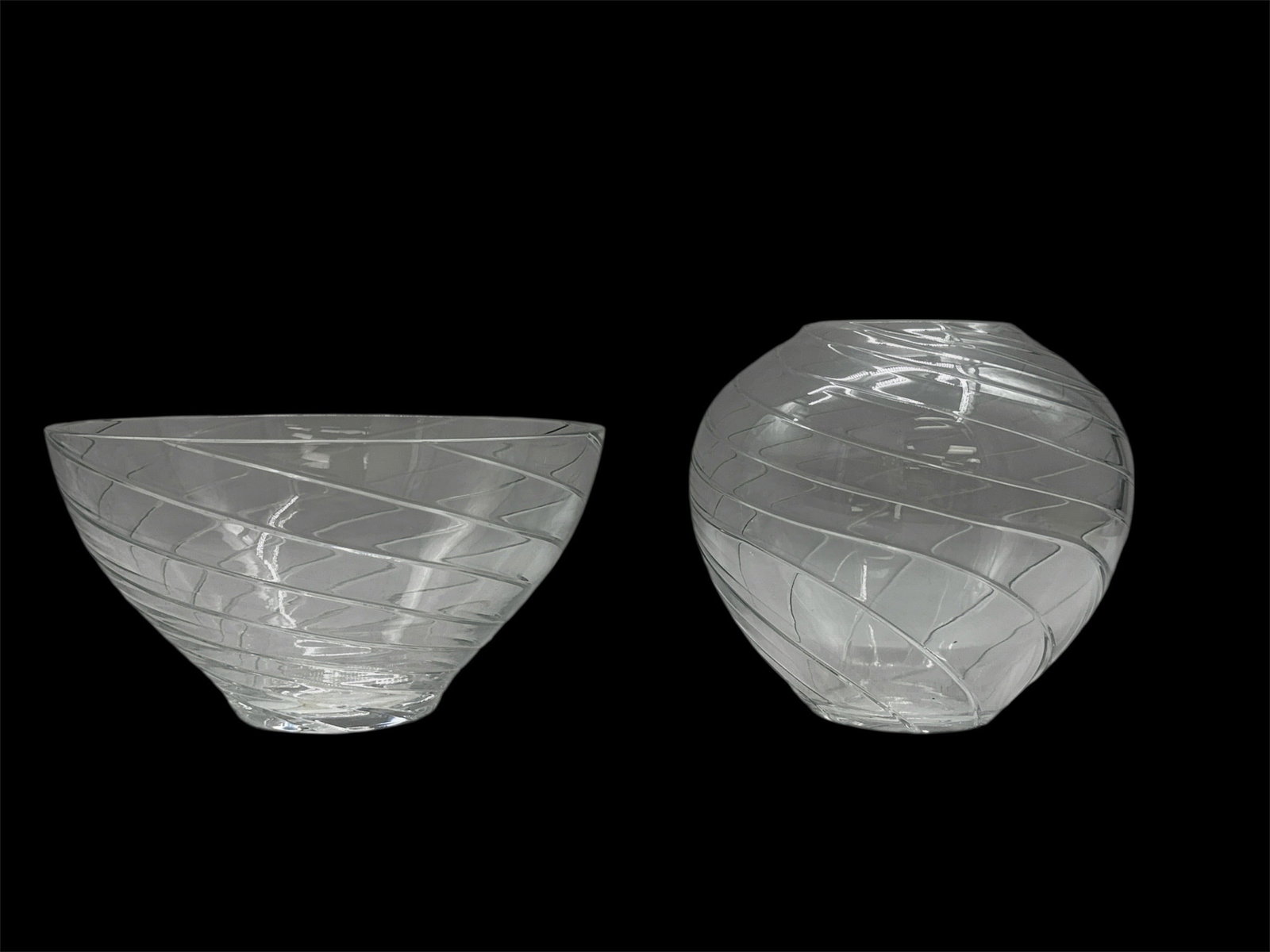 Pair of Contemporary Swirl Pattern Art Glass Bowls: Stylish pair of contemporary clear art glass bowls featuring dynamic etched swirl patterns that wrap fluidly around each form. One bowl presents a wide, open profile ideal for centerpiece use, while t