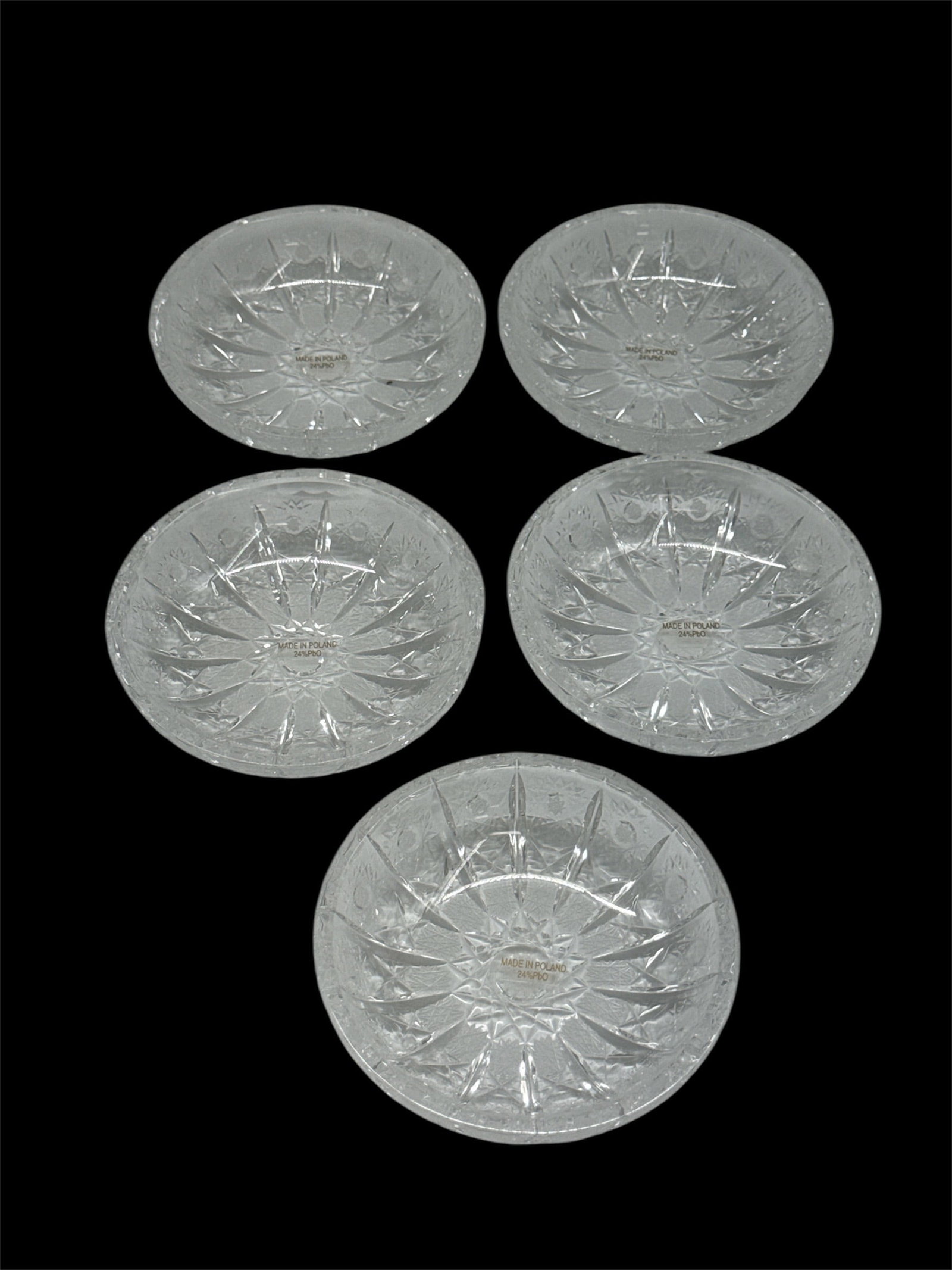 Set of Five Cut Crystal Starburst Coasters or Small Plates: Charming set of five cut crystal coasters or small plates featuring a deeply cut starburst motif radiating from the center. The faceted geometric pattern enhances brilliance and light reflection,