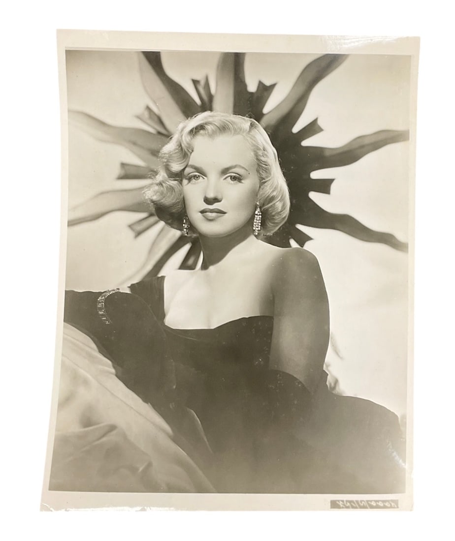 Sunburst Glamour Portrait Type 1 Photograph of Marilyn Monroe: A vintage silver gelatin publicity photograph of Marilyn Monroe, originally captured circa 1950. The image features Monroe in a glamorous studio setting, posed in an off-the-shoulder gown with