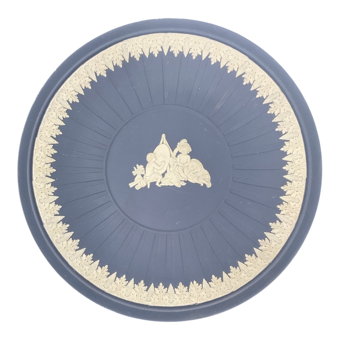 Wedgwood Jasperware Blue Dip Plate with Classical Cherub Scene, 10 Inches: A classic Wedgwood jasperware plate in the iconic matte blue “dip” ground with applied white relief decoration. The center features a finely detailed neoclassical scene of cherubs at play,