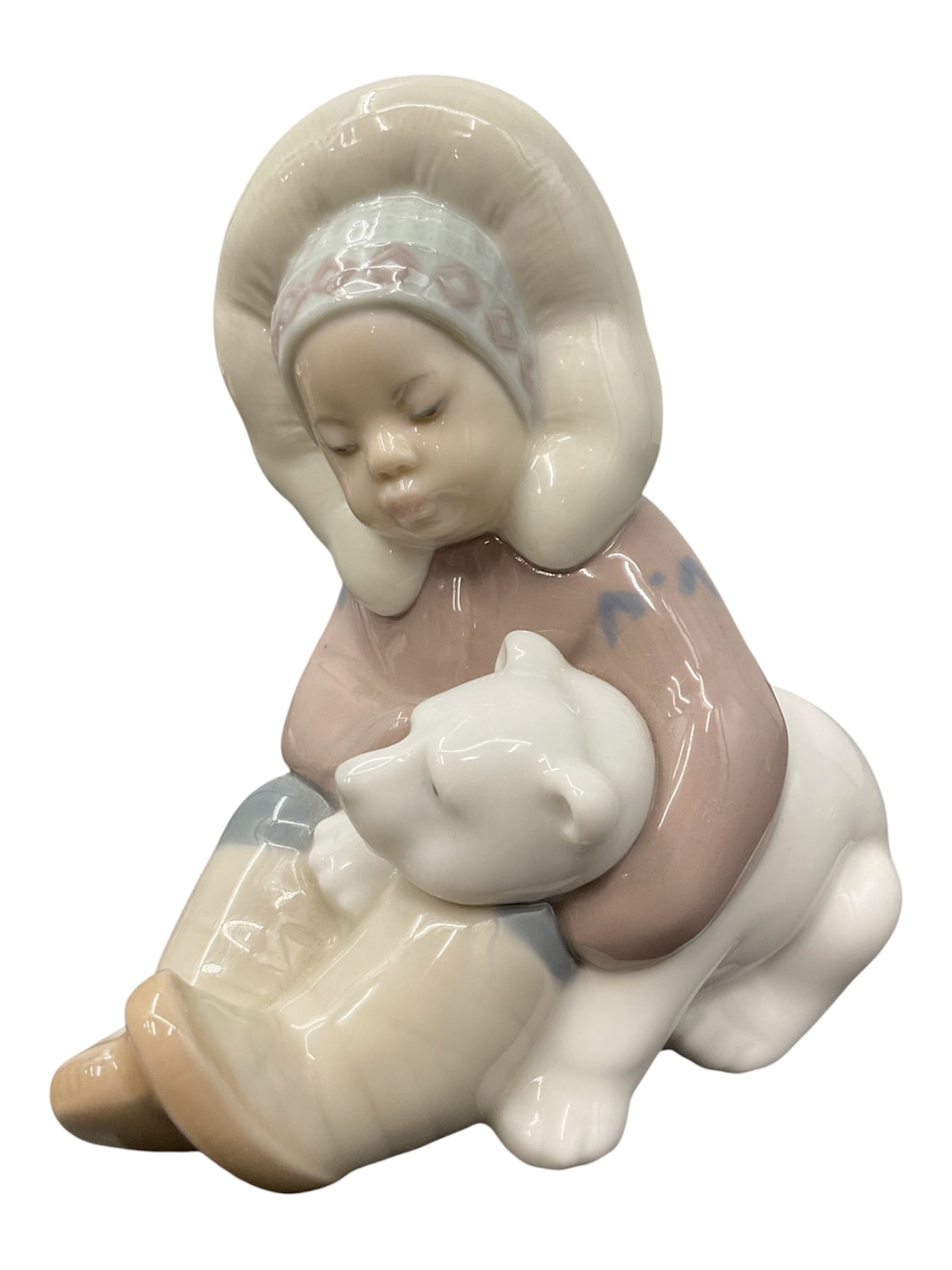 Seated Girl with Dog by Lladro (Spain) Porcelain Figurine: A charming Lladro porcelain figurine depicting a young girl seated beside a small dog, rendered in the soft pastel palette characteristic of the Spanish maker. The child wears a bonnet and simple dres