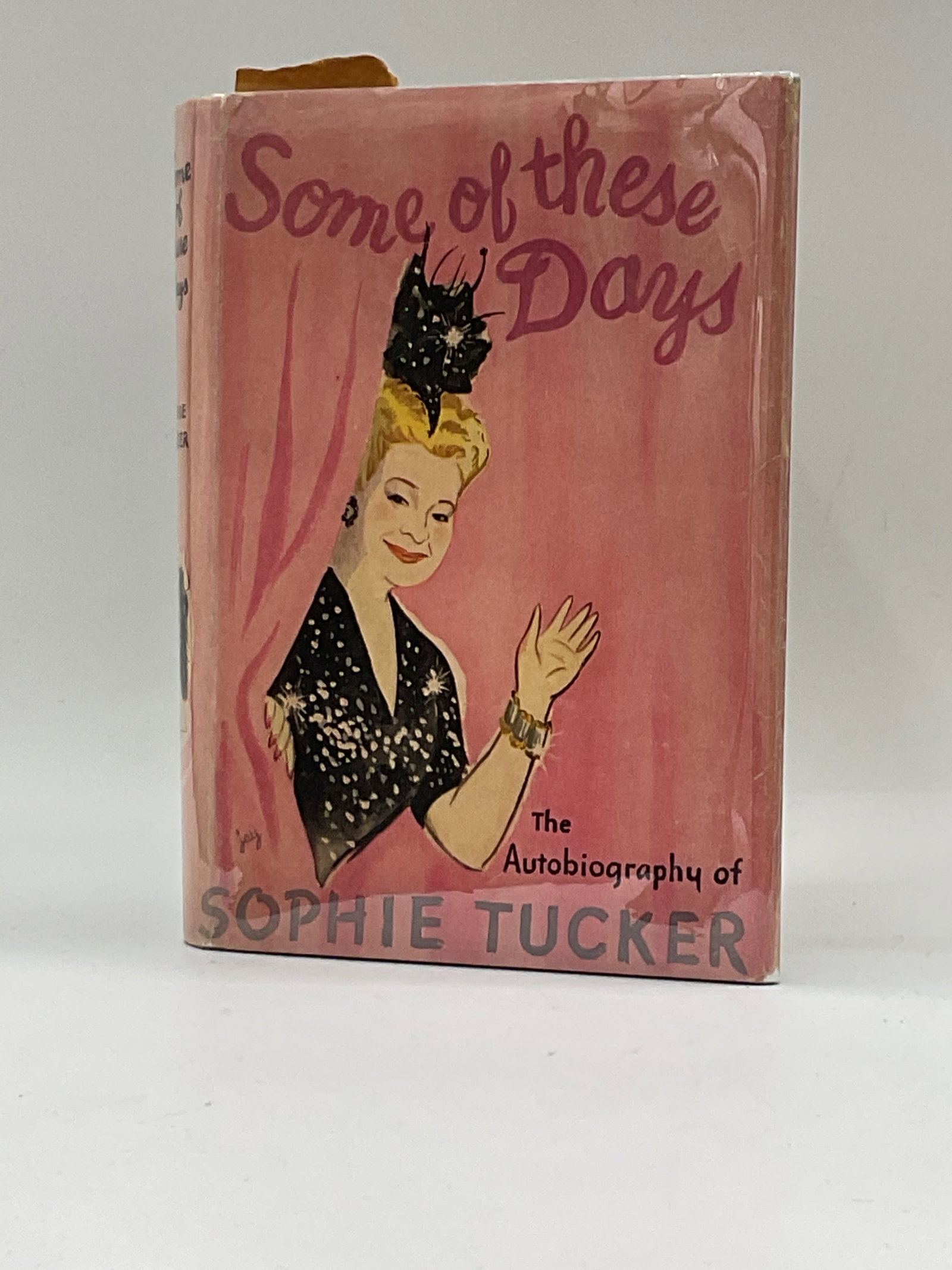 Some of These Days: The Autobiography of Sophie Tucker (Signed Copy): Hardcover first edition of Sophie Tucker’s autobiography Some of These Days, featuring an illustrated pink dust jacket. This copy is personally inscribed and signed by Sophie Tucker, adding sign