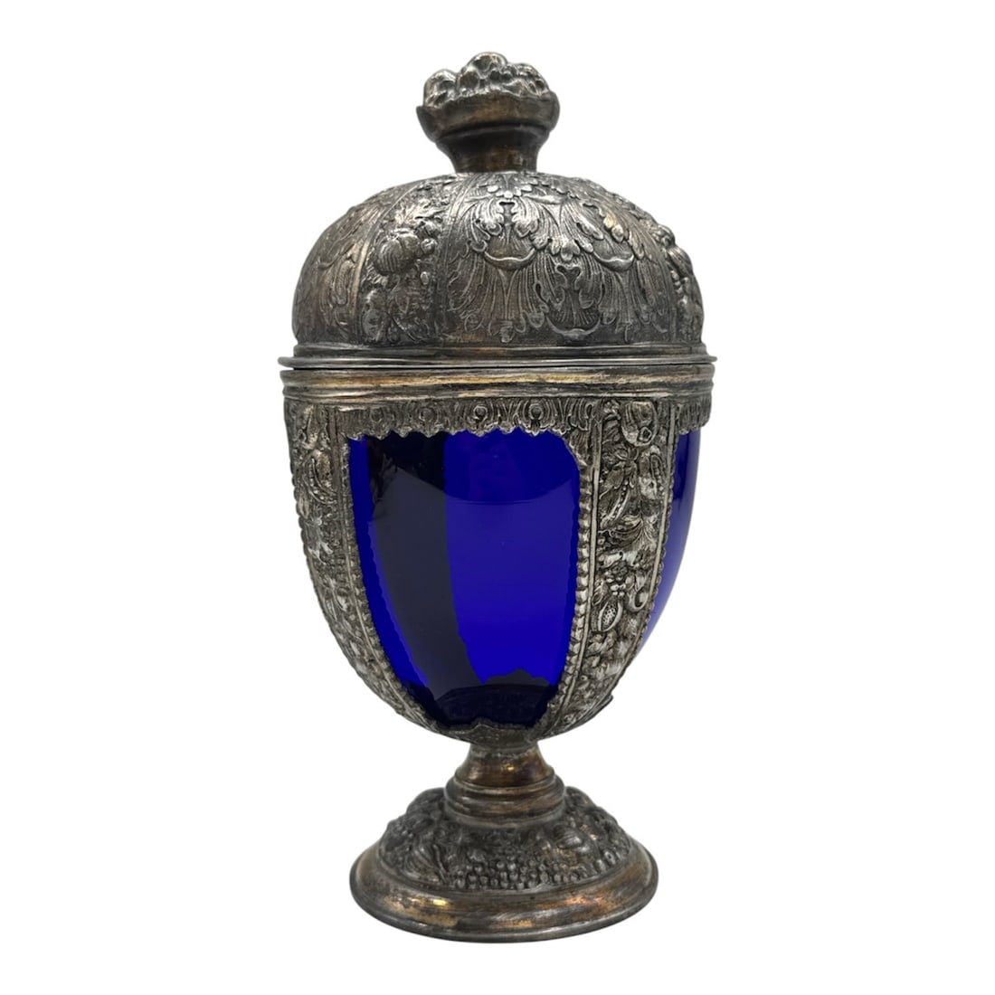 "Cobalt Blue Glass Cup with Silver-Plated Mounts" by Jean-Baptiste C. Desvignes (France,: This elegant 19th-century French centerpiece features a vibrant cobalt blue glass body encased in an ornate silver-plated mount. The decorative metalwork is executed in a lush Neo-Renaissance or Rococ
