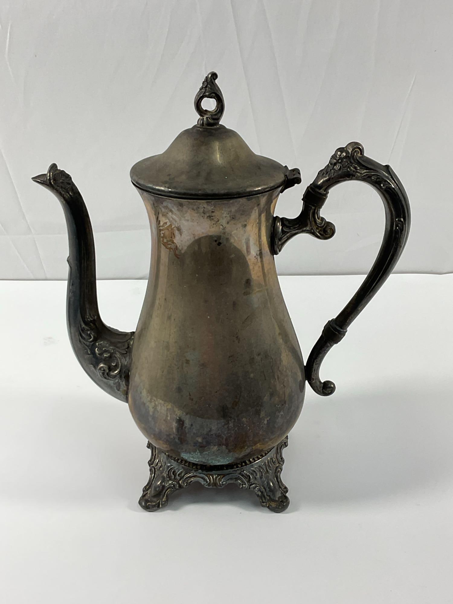 Vintage 1901 Victorian Rose Rogers & Son Silver-Plated Ornate Coffee or Tea Pot: This is an antique silver-plated coffee or tea pot featuring ornate Rococo-style handles, a decorative lid finial, and an elegant curved spout. The raised floral and scrollwork detailing on the handle
