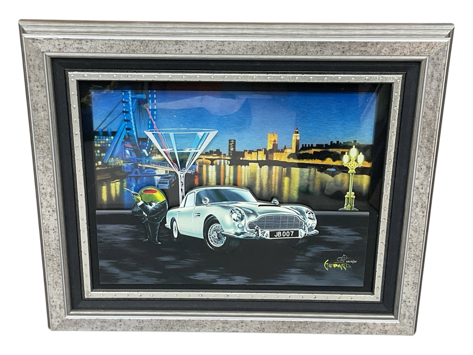 "Bond 007" by Michael Godard (American, b.1958) Mixed Media: A playful mixed media artwork featuring a silver Aston Martin DB5, oversized martini glass, and one of Godard’s signature olive characters with a gun, all set against a stylized London cityscape