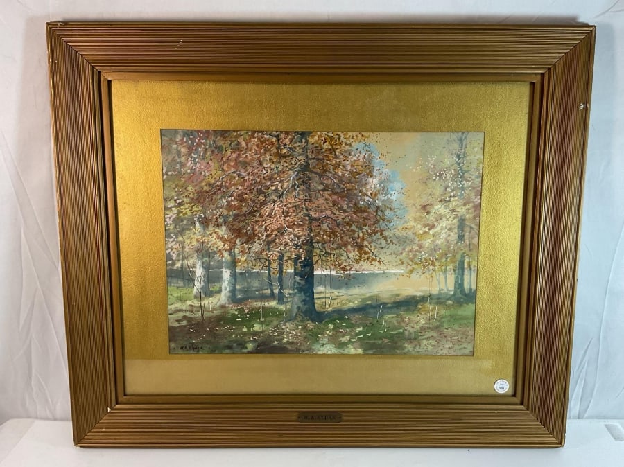 Walter Eyden (America, 1881-1965) Watercolor: This artwork by American artist Walter Eyden features a serene autumn landscape, showcasing trees with vibrant fall foliage in shades of orange, gold, and brown, with soft sunlight filtering through t