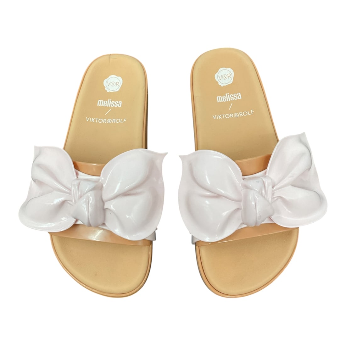 Melissa x Viktor & Rolf Bow Slide Sandals, Size 8: Chic and playful, these Melissa x Viktor & Rolf slide sandals feature a bold oversized bow design across the vamp, showcasing the designers’ signature avant-garde aesthetic. Crafted from Mel