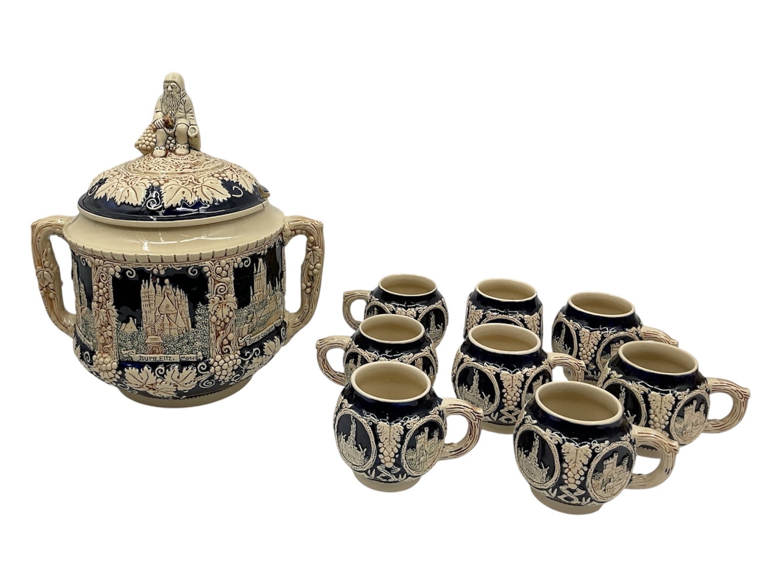 German Punchbowl Set: This 9-piece ceramic set features a decorative covered tureen and eight matching cups, all characterized by a bold, black and cr