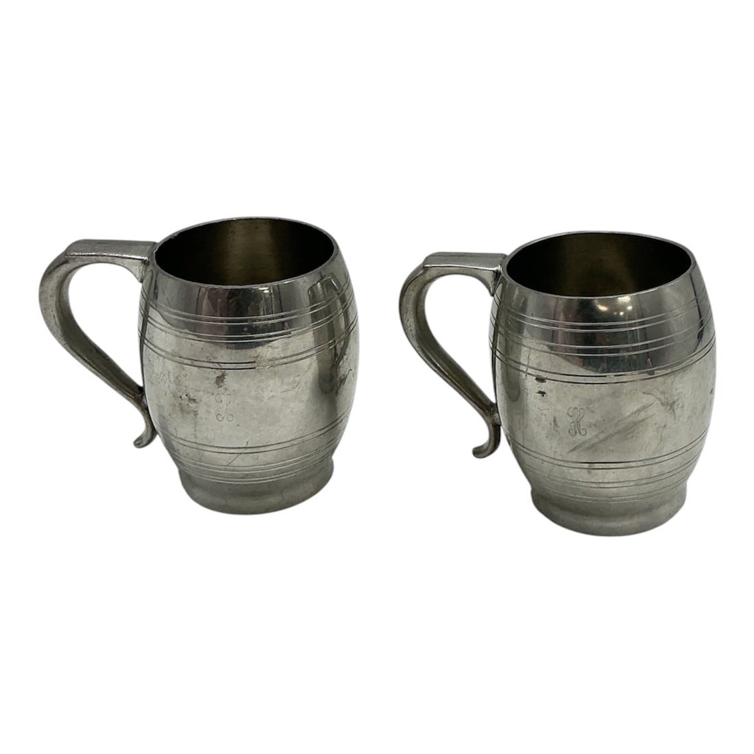 Pair of Boardman Colonial Pewter Tankards No. 303: A pair of pewter tankards by Boardman, marked Colonial Pewter by Boardman with maker’s touchmarks and form number 303 on the underside. Each mug features a classic barrel-form body with incised 