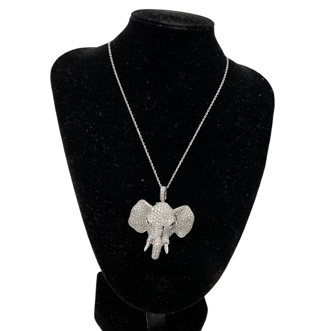 Diamond Elephant Pendant Necklace: A striking pendant necklace featuring a stylized elephant-form pendant fully adorned with pavé-set natural diamonds. The sculptural design showcases oversized ears and elongated trunk details, 