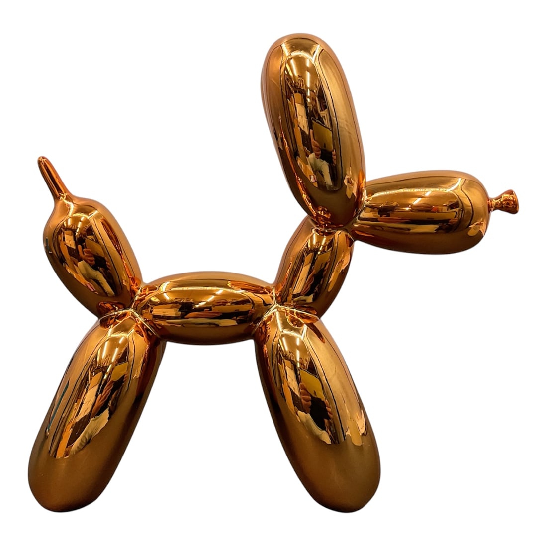 Contemporary Balloon Dog Style Copper Finish Sculpture: Contemporary decorative sculpture modeled after a balloon animal dog with a highly reflective copper-tone metallic finish. The stylized form is composed of elongated balloon-like segments in the manne