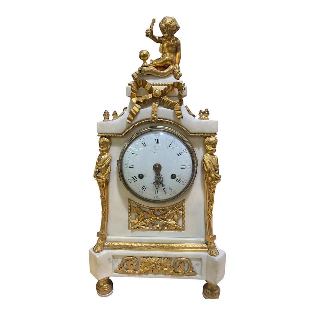 AQ051 - 19th Century French Style Onyx and Dore Bronze Clock with Cupid Figure: A finely detailed mantel clock executed in the style of 19th century French decorative arts, featuring a white onyx case richly adorned with dore bronze mounts and crowned by a sculptural cupid figure