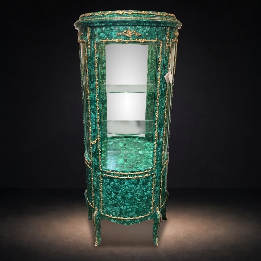 MC153 - 19th Century Russian Malachite and Dore Bronze Vitrine Cabinet: An exceptional 19th century Russian Malachite vitrine cabinet executed, featuring richly patterned malachite throughout and accented with finely cast dore bronze mounts. The cylindrical form is b