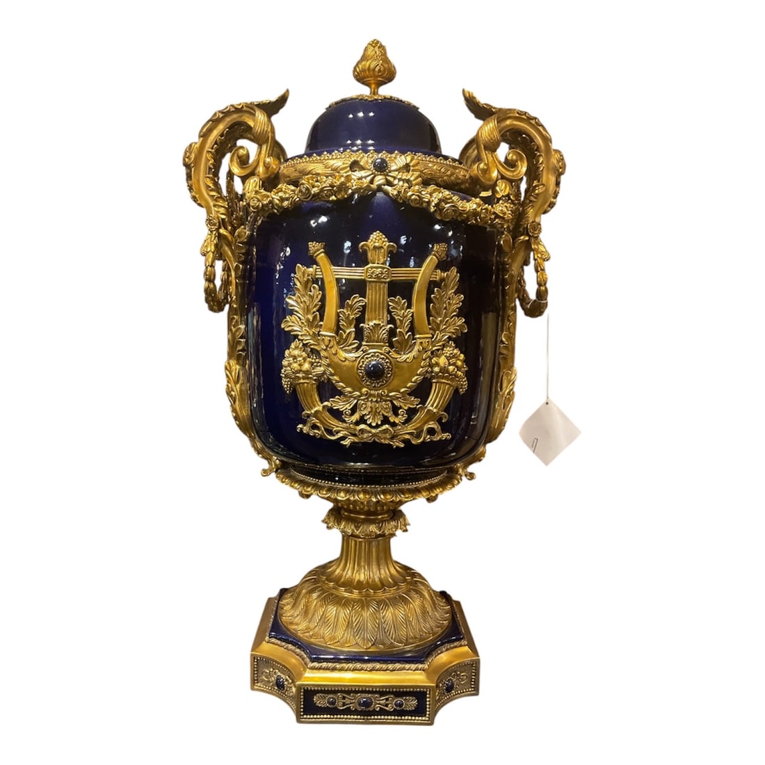 PC756 - Pair of Blue Porcelain and Dore Bronze Mounted Vases in the Empire Taste: An impressive pair of porcelain vases featuring a deep cobalt blue ground, richly adorned with elaborate dore bronze mounts in the grand Empire style. Each vase is executed in a classical covered urn 
