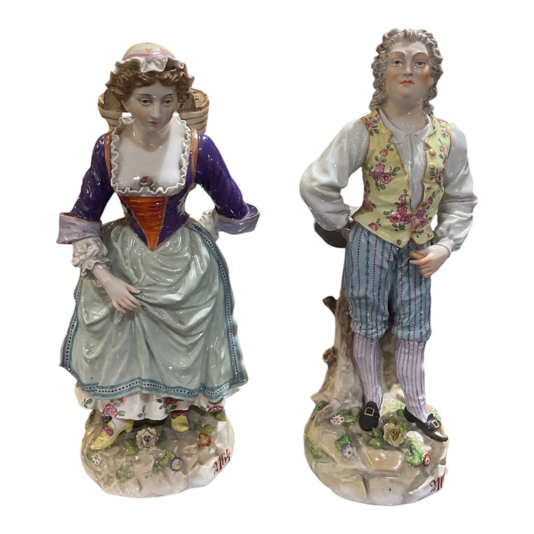 PC478 - Pair of Dresden Porcelain Figures of Man and Woman: A finely modeled pair of Dresden porcelain figures depicting a man and woman in traditional European attire, executed with detailed hand-painted decoration and expressive character. Each figure stands