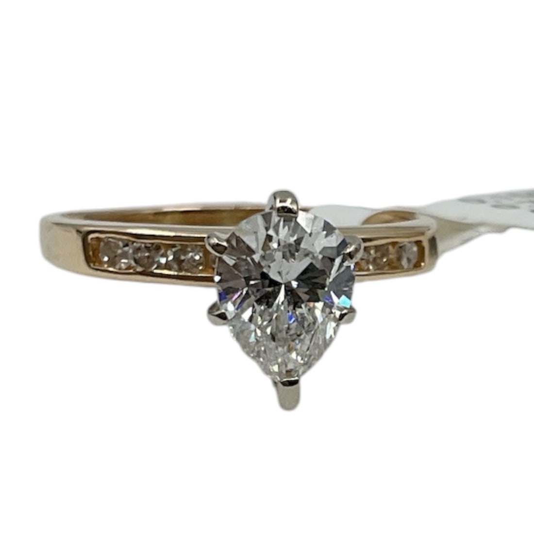 14K Gold Diamond Engagement Ring with AIGL Appraisal: A classic 14K gold engagement ring set with a prominent pear-shaped diamond at center, secured in a prong setting. The band is accented with a row of smaller round diamonds along the shoulders, adding