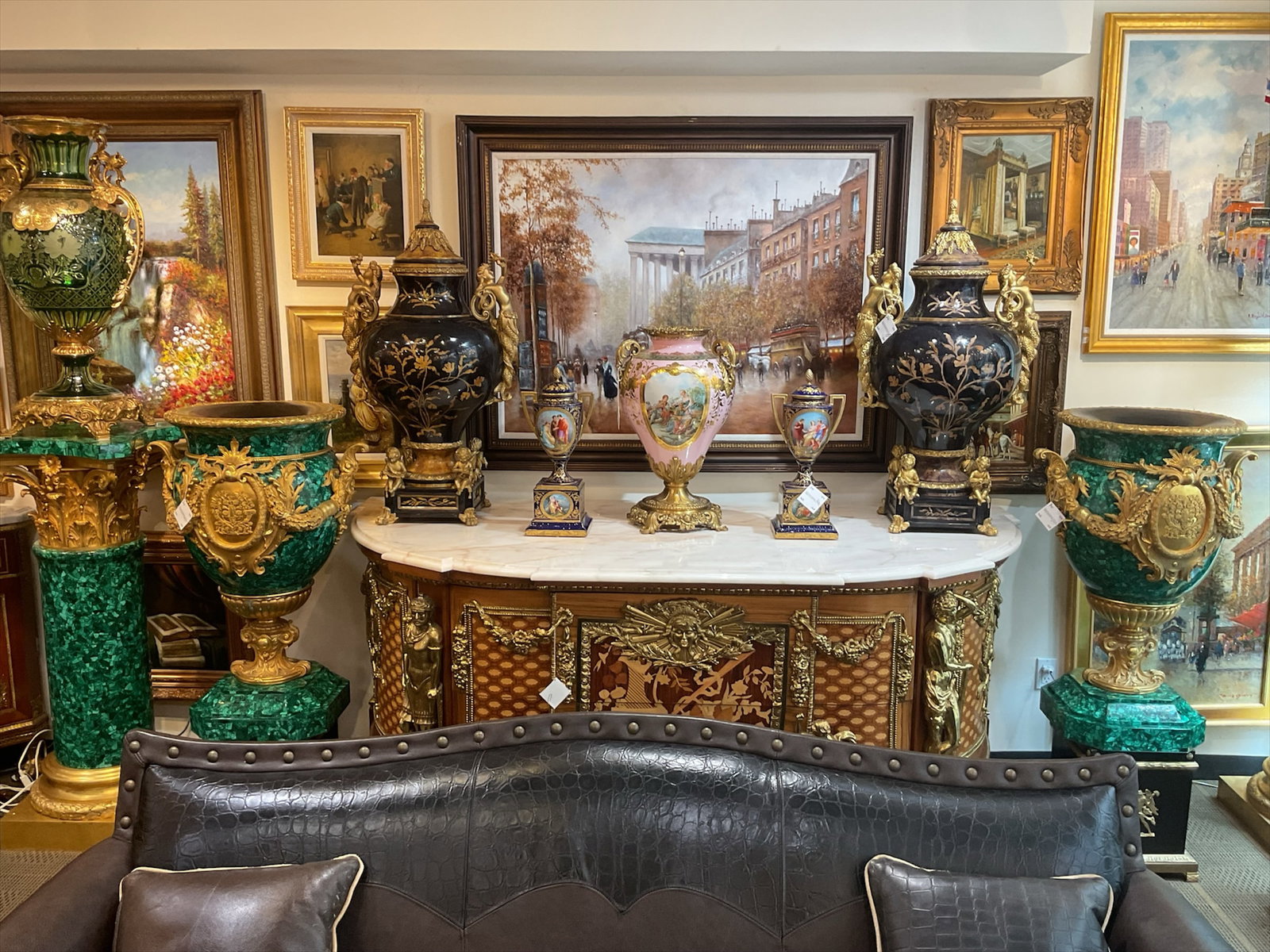 FR084 - Dore Bronze and Marble Sideboard in the Neoclassical Taste: An extraordinary sideboard executed in a richly ornamented neoclassical style, combining a shaped marble top with an elaborately mounted dore bronze case. This piece exemplifies exceptional craftsmans