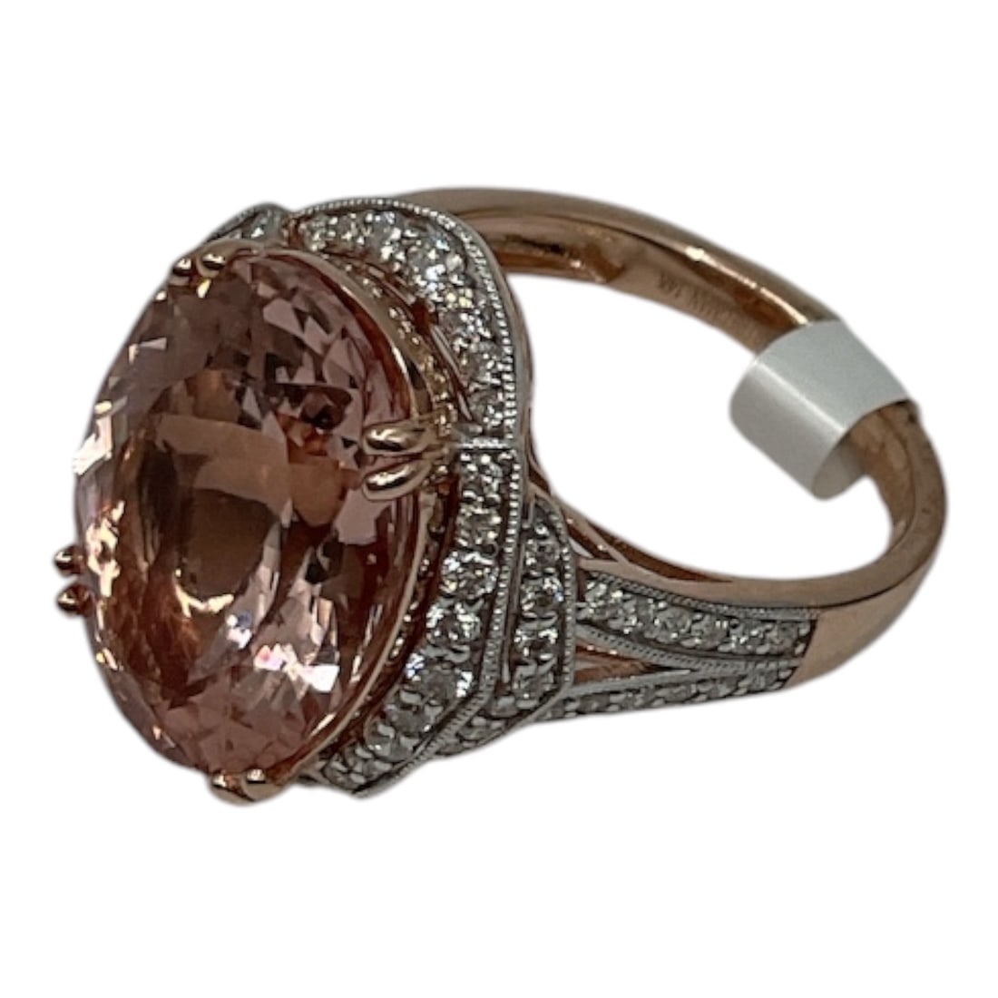 18K Rose Gold Morganite and Diamond Ring with AIGL Appraisal: A stunning ring crafted in 18K rose gold, featuring a large oval-cut morganite at center with a soft blush-pink hue. The center stone is accented by a halo of round brilliant cut diamonds, with additi