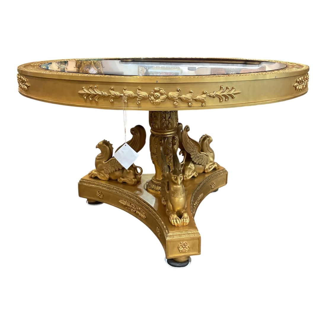 LC128 - Lapis and Dore Bronze Center Table with Mythological Figures: An exceptional center table executed in a grand neoclassical style, featuring an ornate dore bronze base adorned with mythological creatures and a circular top incorporating a polished stone or glass 