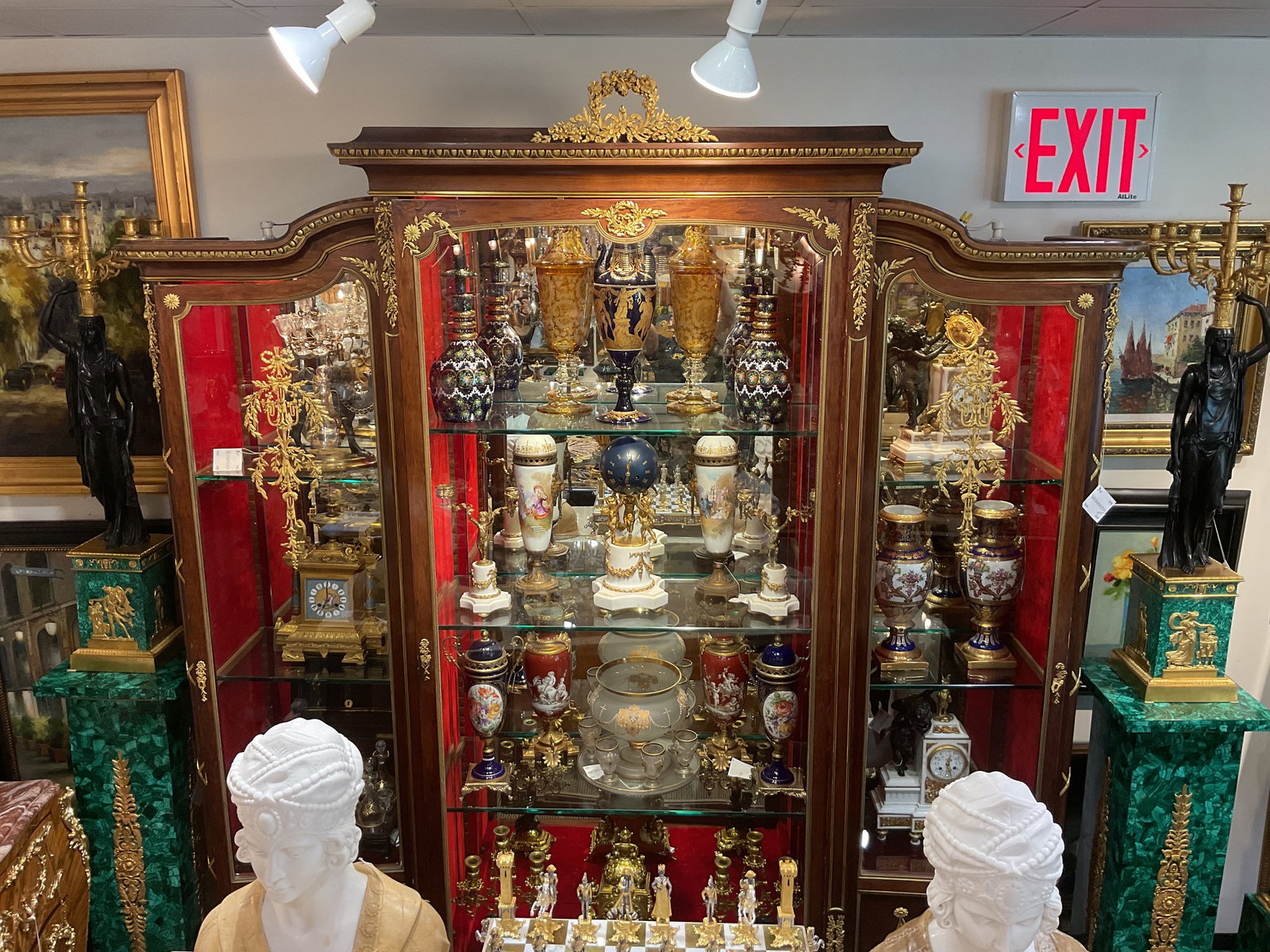 FR196 - Louis XV Style Three-Door Kingwood Vitrine with Dore Bronze Mounts: An impressive three-door vitrine cabinet crafted in the Louis XV style, executed in richly figured kingwood veneer and adorned with finely cast dore bronze mounts. This elegant display cabinet exempli