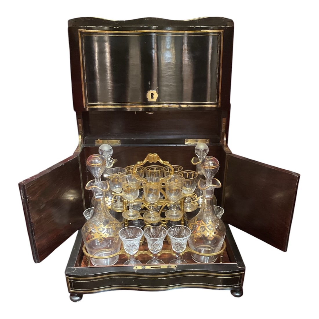 AQ494 - 19th Century French Liquor Tantalus Box with Decanter Set: A refined 19th century liquor tantalus box, elegantly crafted in richly grained wood and accented with delicate brass inlay. This sophisticated piece opens to reveal a complete fitted interior, housin