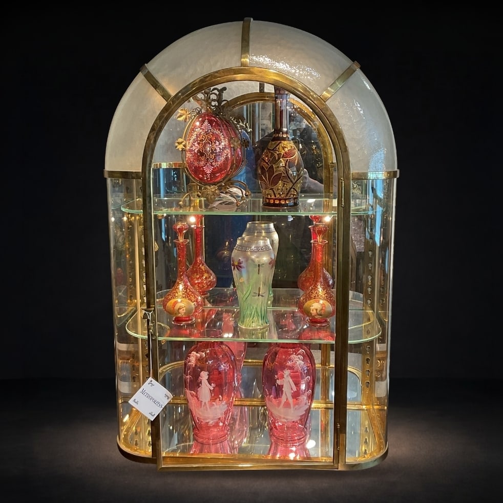 FR247 - French Art Deco Glass and Brass Jukebox Vitrine Cabinet: A striking French Art Deco vitrine cabinet, distinguished by its sculptural arched form, luminous materials, and refined brass framework. This elegant display piece embodies the sleek sophistication a
