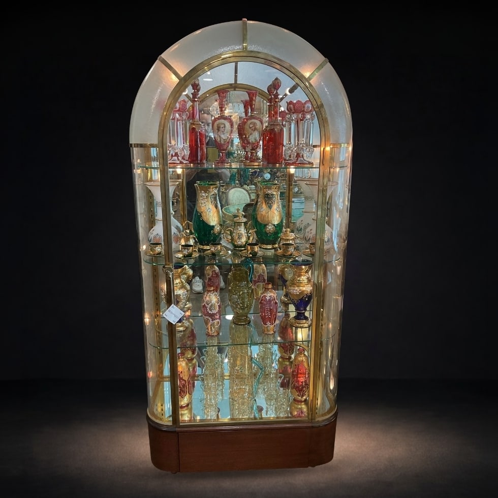 FR246 - French Art Deco Glass and Brass Arched Jukebox Vitrine Cabinet: A refined French Art Deco vitrine cabinet, showcasing a graceful arched silhouette and a harmonious blend of glass and brass. This elegant display piece reflects the streamlined sophistication and lum