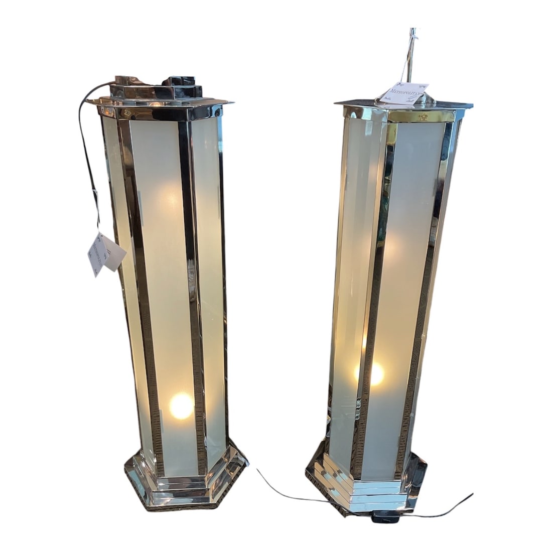 PD075 - Pair of Art Deco Frosted Crystal Illuminated Pedestals: A sleek and architectural pair of Art Deco illuminated pedestals, executed in frosted crystal with polished chrome framing. These striking pieces combine functional lighting with sculptural design, em