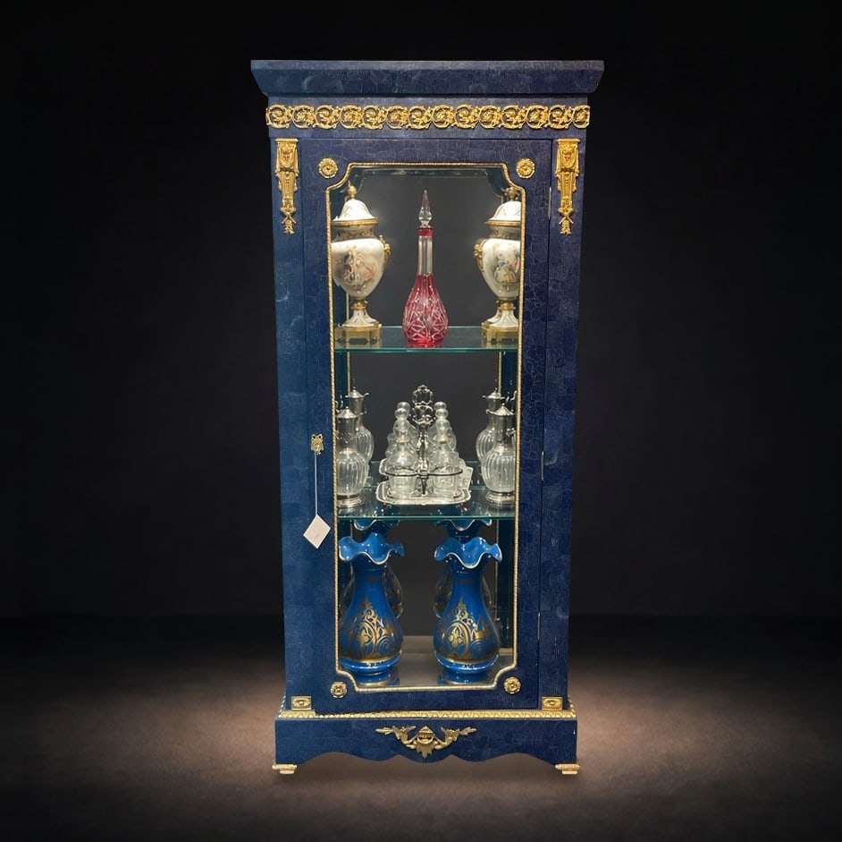 LC109 - Lapis and Dore Bronze Vitrine Cabinet: A refined and elegant display vitrine, executed in richly figured lapis and adorned with finely cast dore bronze mounts. This striking cabinet exemplifies classical European luxury design, combin
