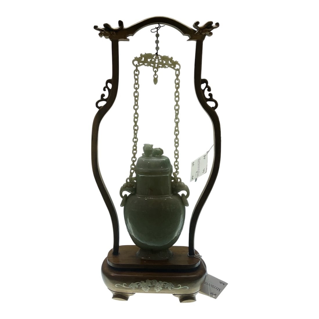 JD962 - Chinese Jade Covered Vase with Foo Dog Finial in Carved Wood Stand: An elegant and finely carved jade covered vase, suspended within a decorative hardwood display stand. This refined piece reflects traditional Chinese craftsmanship, combining the natural beauty of jad