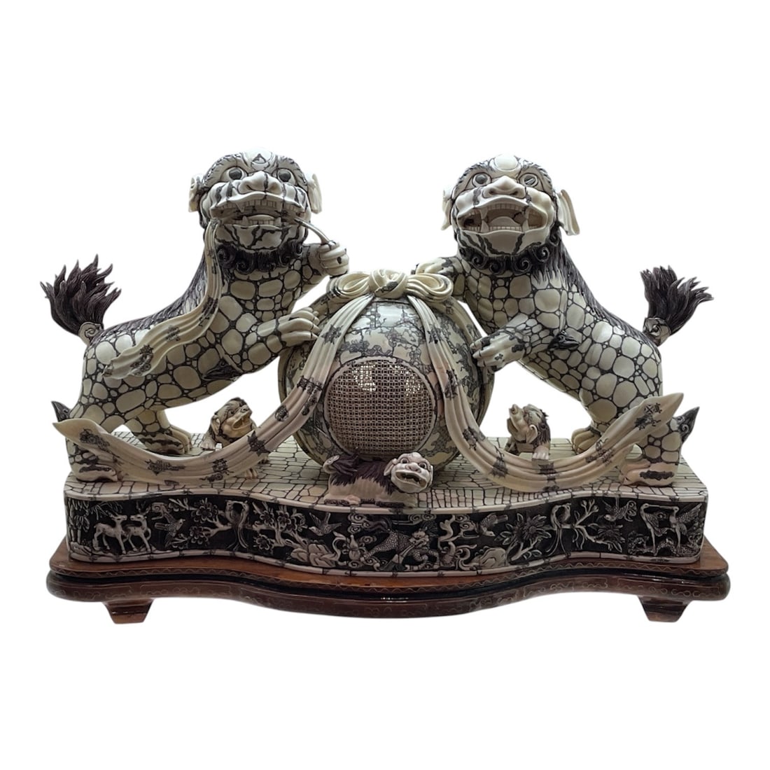 IC1132 - Carved Asian Foo Lion Group with Reticulated Concentric Ball on Hardwood Base: An exceptional and highly intricate carved figural group depicting a pair of guardian foo lions with a central reticulated concentric ball, symbolizing protection, strength, and unity. This elaborate 