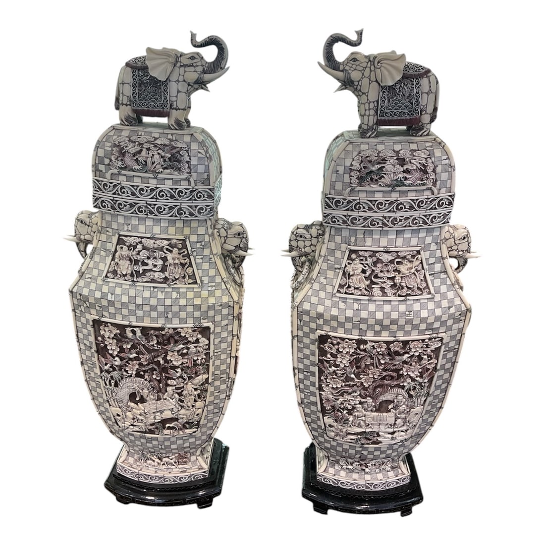 IC1572 - Pair of Large Asian Carved Vases with Elephant Finials: An impressive pair of large, intricately carved vases featuring elaborate figural and decorative motifs throughout, surmounted by finely detailed elephant finials. These statement pieces showcase exce