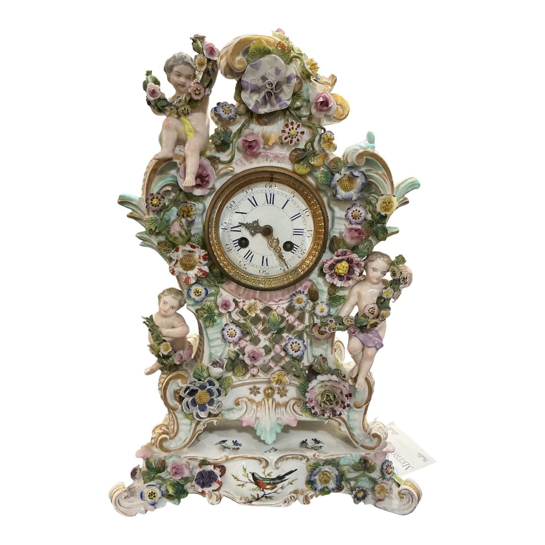 PC619- 19th Century Meissen Porcelain Figural Clock with Cherubs: An exceptional 19th century Meissen porcelain clock, richly decorated with floral elements and charming cherub figures, exemplifying the elegance and craftsmanship of the renowned German manufactory.