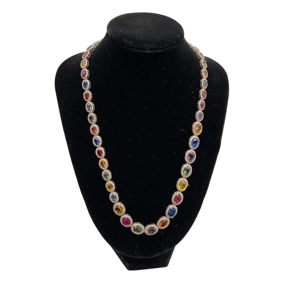 14K Gold Sapphire and Diamond Necklace with AIGL Appraisal: An elegant 14K yellow gold necklace set with 46 oval-shaped natural sapphires in a vibrant array of colors, accented by numerous round brilliant cut diamonds throughout. The graduated design showcases