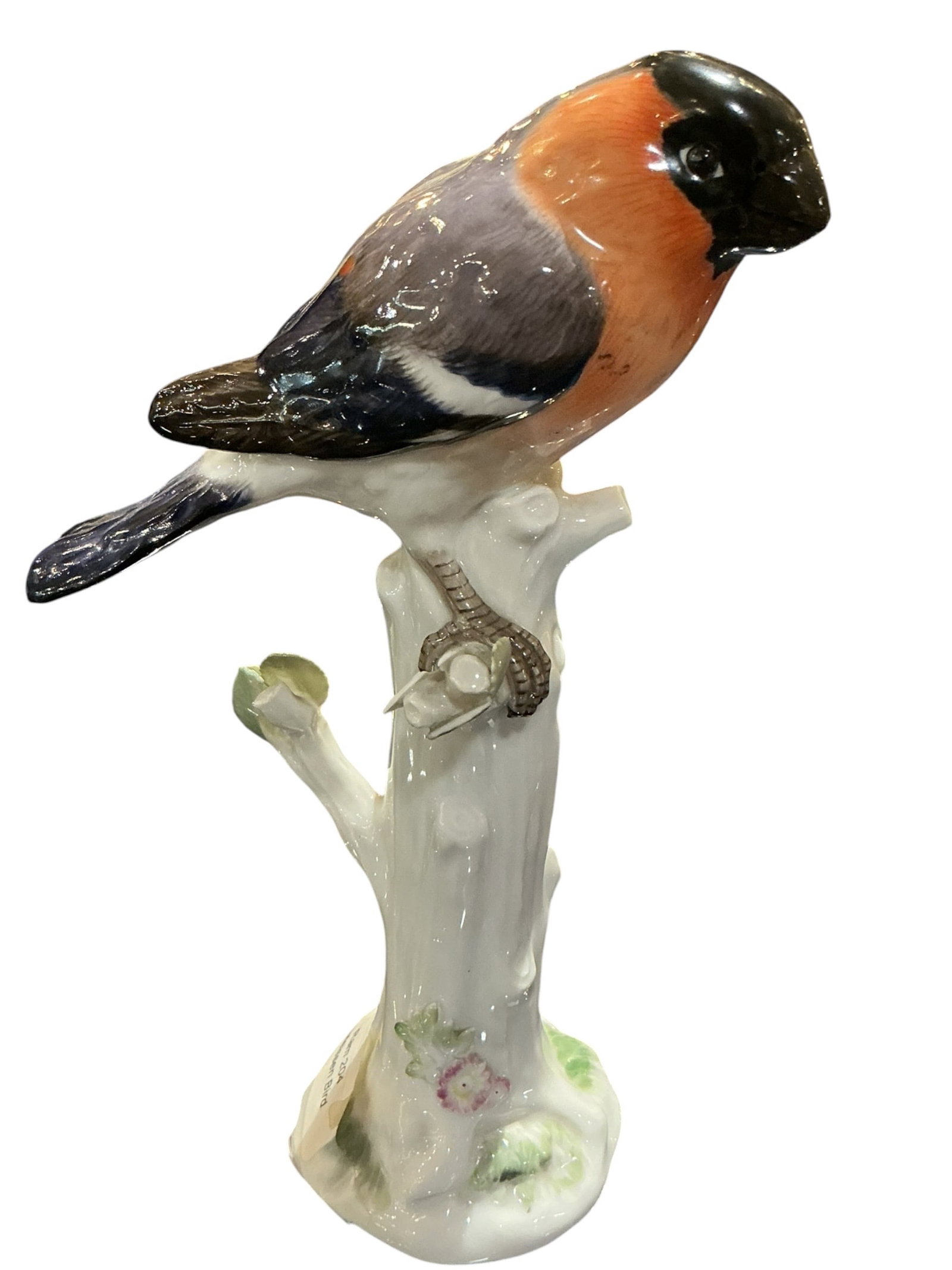 RAM204 - Meissen Porcelain Bird on Perch: A finely modeled Meissen porcelain figure depicting a bird perched on a naturalistic branch, executed with the precision and artistry characteristic of the renowned German manufactory.