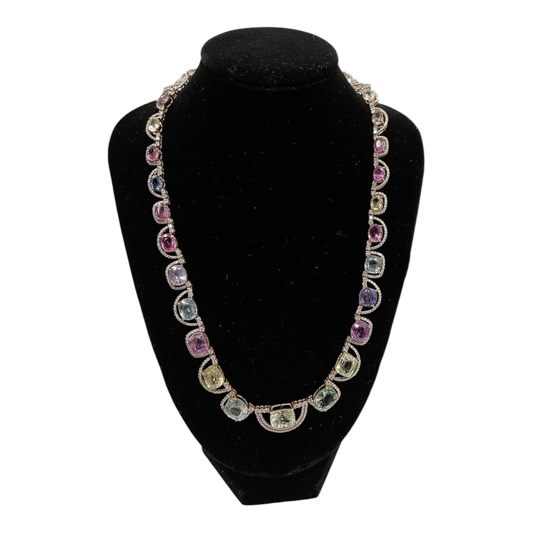 18K Gold Multi Color Sapphire and Diamond Necklace with GIA & AIGL Reports: An exceptional 18K gold necklace set with a vibrant array of multi-colored sapphires, each individually framed by halos of round brilliant cut diamonds. The graduated design showcases a spectrum of