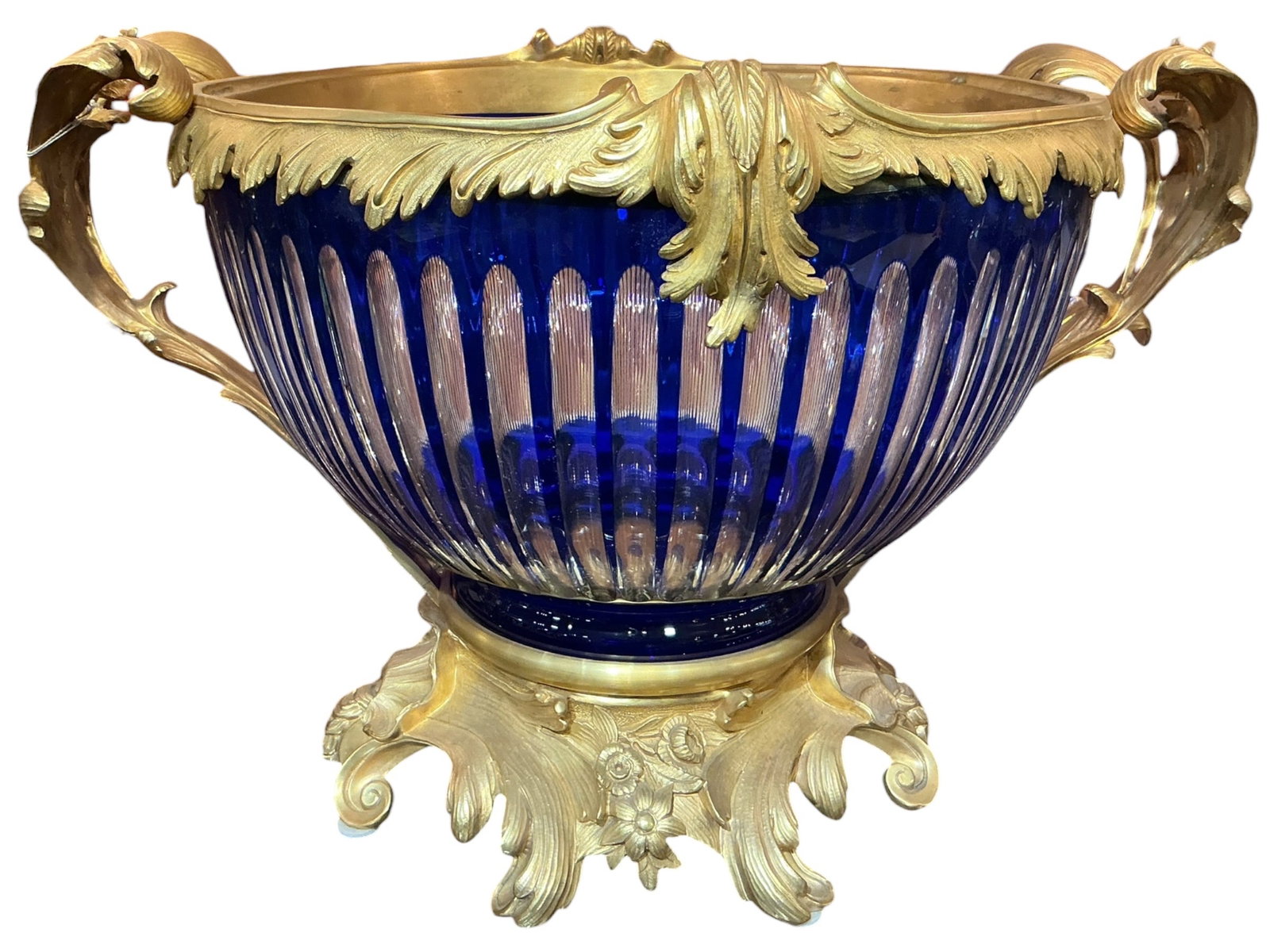 CS419 - Blue Crystal and Dore Bronze Mounted Center Bowl: A striking center bowl crafted in vibrant blue crystal and richly mounted with dore bronze, designed in an opulent classical style. The bowl features a fluted crystal body with vertical ribbing,