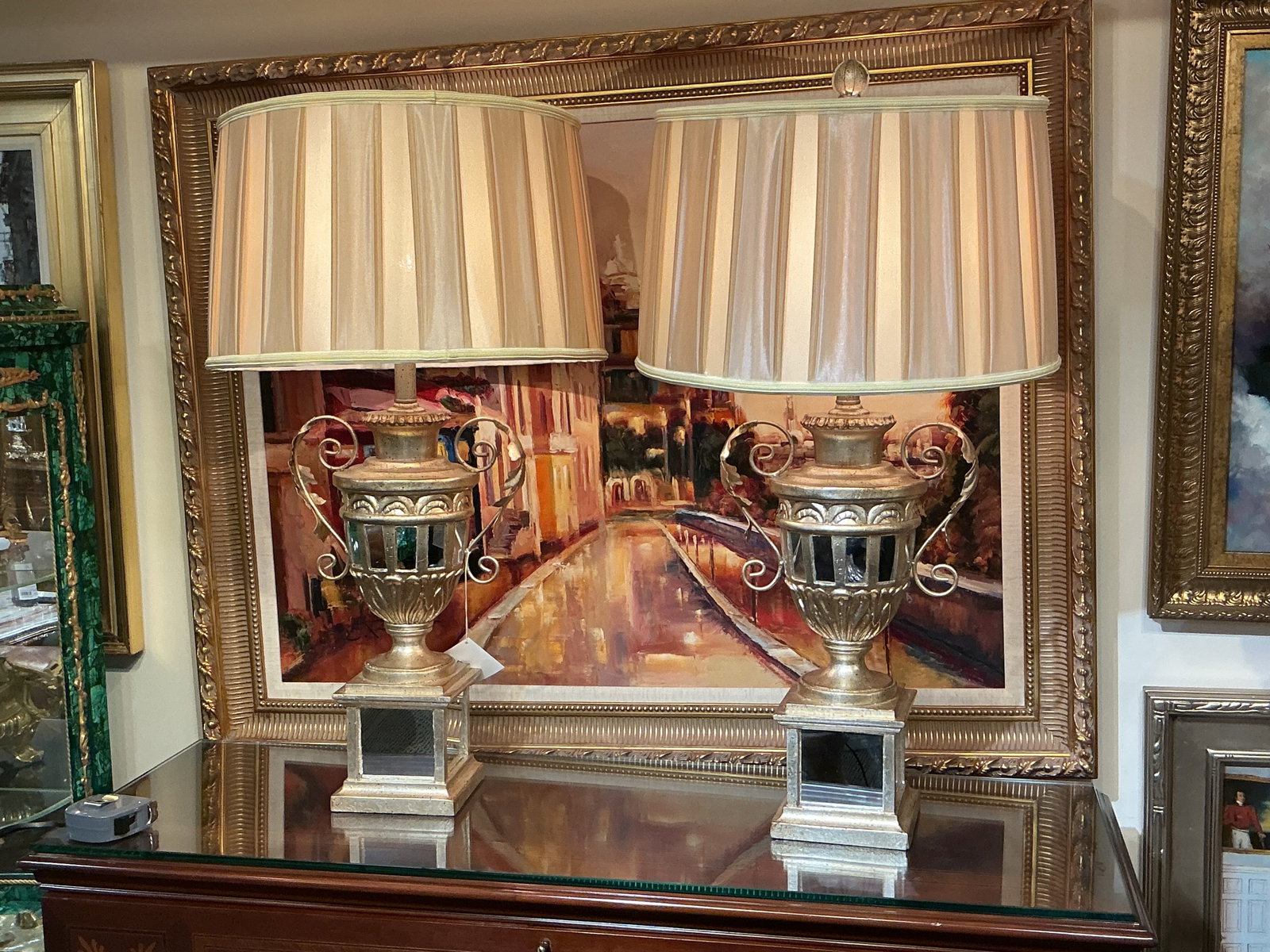 LM082 - Pair of Silvered Bronze and Mirrored Table Lamps: An impressive pair of table lamps crafted in silvered bronze with integrated mirrored elements, designed in an elaborate classical style. Each lamp features an urn-form body richly detailed with layer