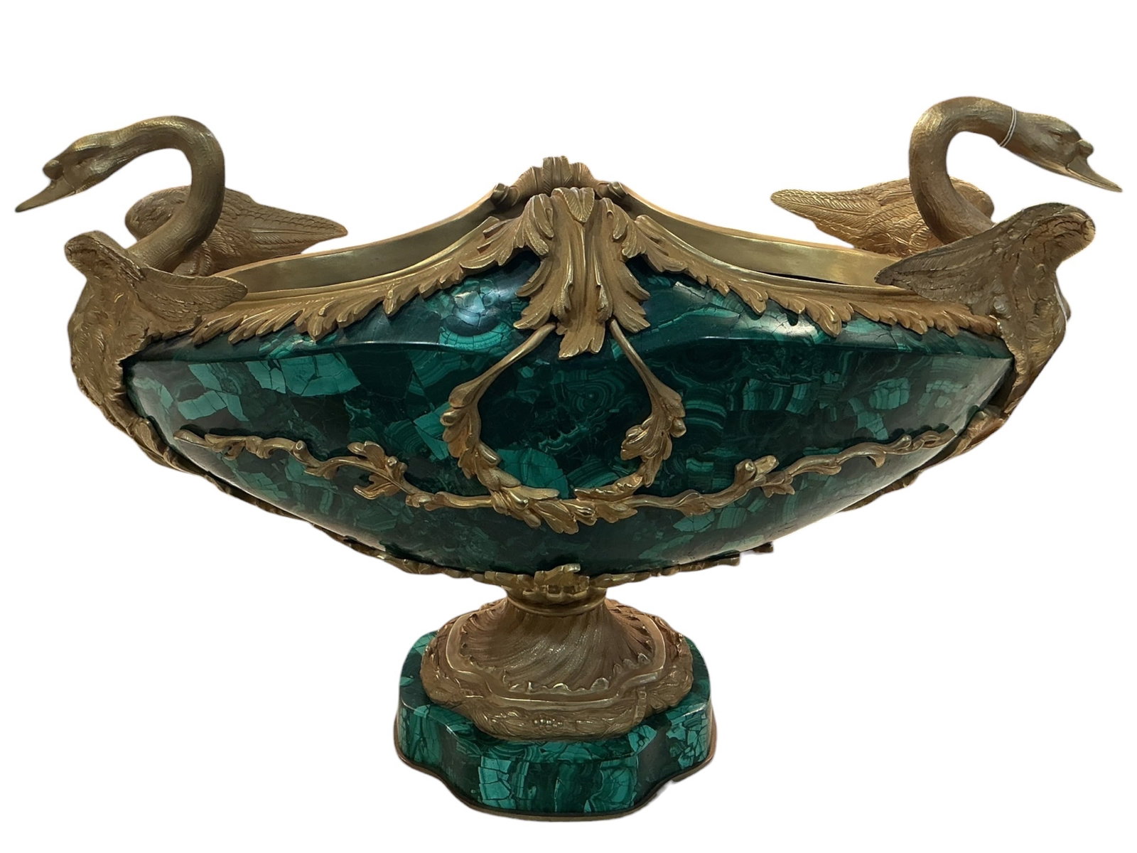 MC069- Malachite and Dore Bronze Bowl with Swan Handles: A striking decorative bowl crafted in richly patterned malachite and adorned with finely cast dore bronze mounts, designed in a classical European style. The oval body showcases vivid green malachite 