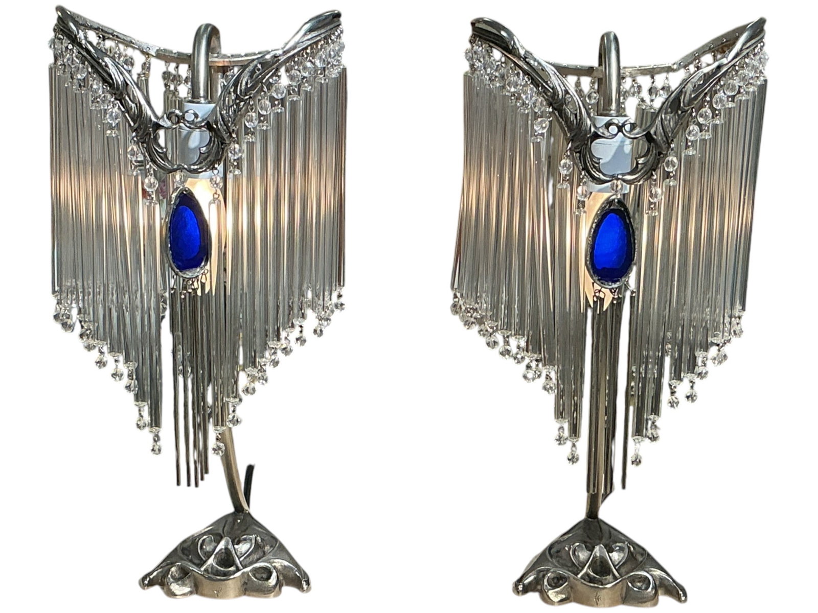 LM130 - Pair of Art Deco Style Lamps with Crystal Rod Fringe: A distinctive pair of Art Deco style table lamps featuring a striking combination of metalwork and cascading crystal rod fringe. Each lamp is designed with a sculptural, curved frame supporting a dram