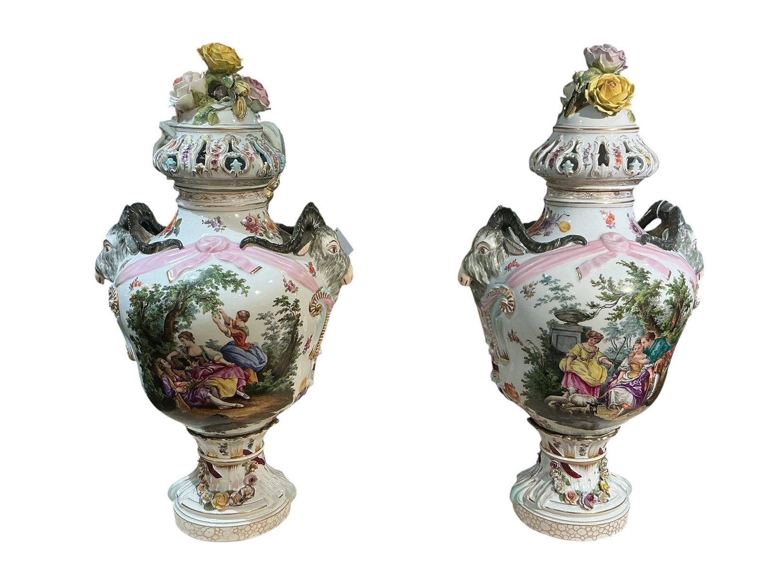 PC561- Pair of 19th Century Dresden Porcelain Vases with Romantic Scenes: A finely executed pair of 19th century Dresden porcelain vases, richly decorated with hand-painted romantic figural scenes and elaborate floral ornamentation. Each vase is formed in a classical urn sh