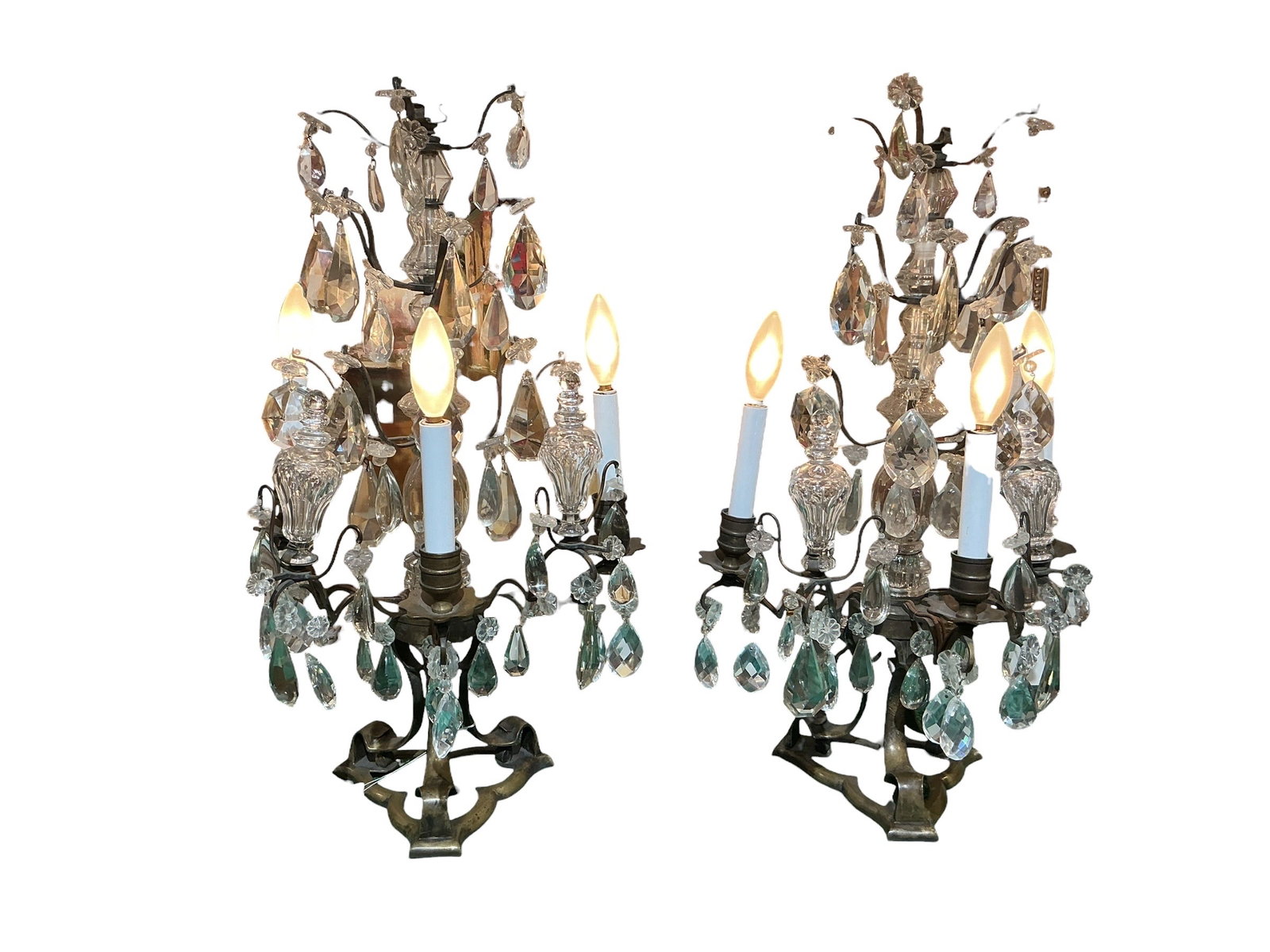 AQ150 - Pair of 19th Century Baccarat Crystal Three-Light Girandole Lamps: A refined pair of 19th century style girandole lamps featuring bronze frames adorned with Baccarat crystal prisms, executed in an elegant and highly decorative design. Each lamp is constructed with a 