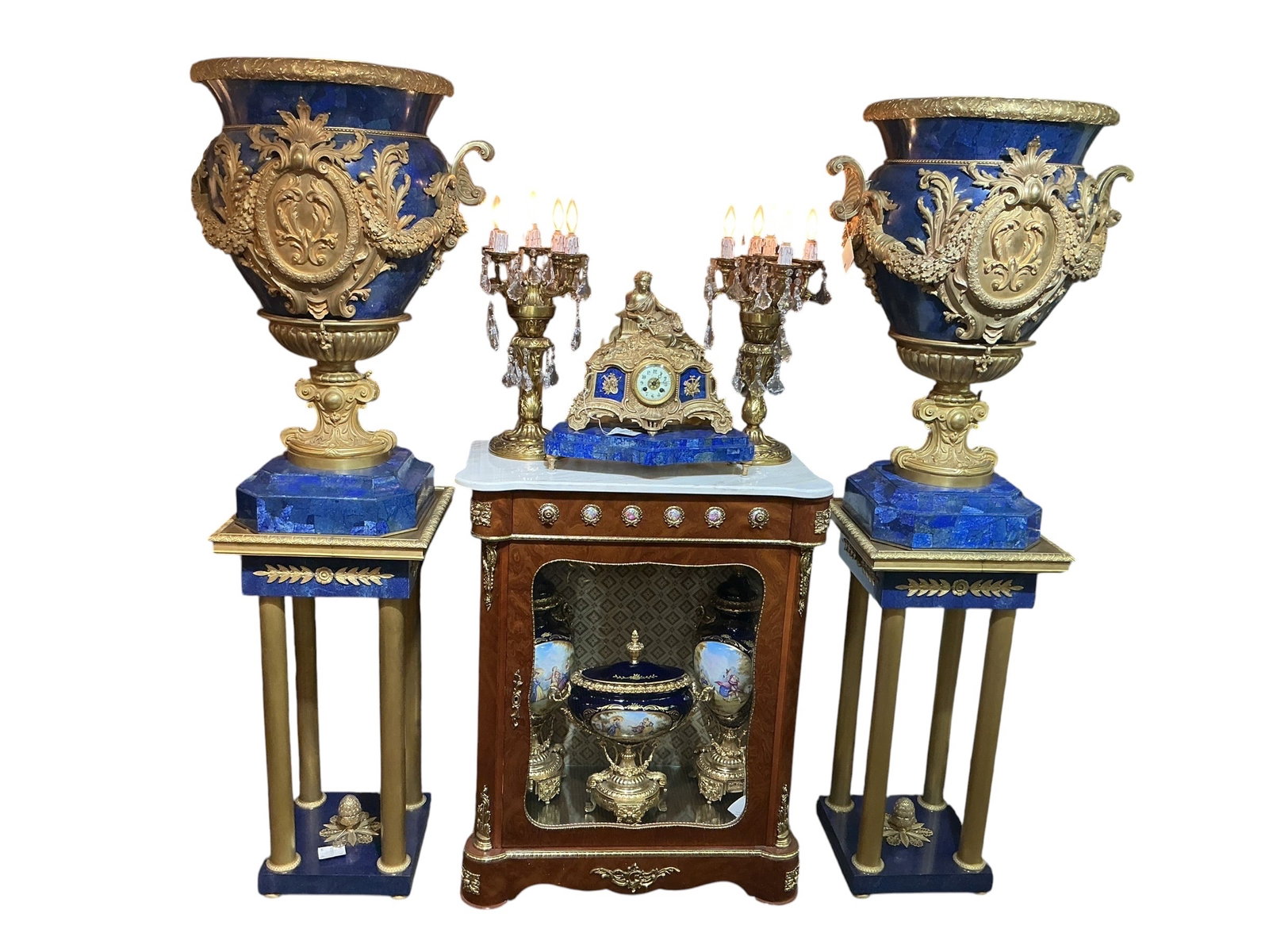 LC105- Pair of Lapis Lazuli and Dore Bronze Pedestals: An elegant pair of pedestals crafted in richly colored lapis lazuli and accented with dore bronze mounts, designed in a refined neoclassical style. Each pedestal features a square top and base veneere