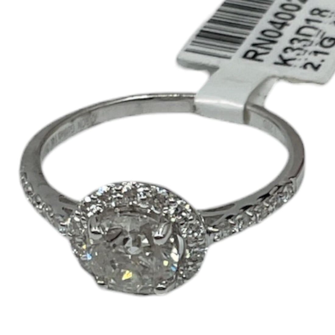 14K White Gold Diamond Ring with AIGL Appraisal: A classic and elegant ring crafted in 14K white gold, featuring a round brilliant cut diamond at center. The centerpiece is surrounded by a halo of smaller diamonds, with additional diamonds set along