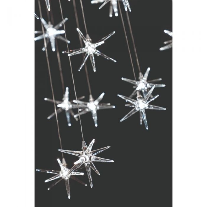 Reflex Stella Chandelier 50 Transparent Stars: The Stella Chandelier from Reflex is made in Italy. The pendant stars are the main focus of this very unique piece in Murano glass. Hanging transparent glass and a mirrored glass top support are