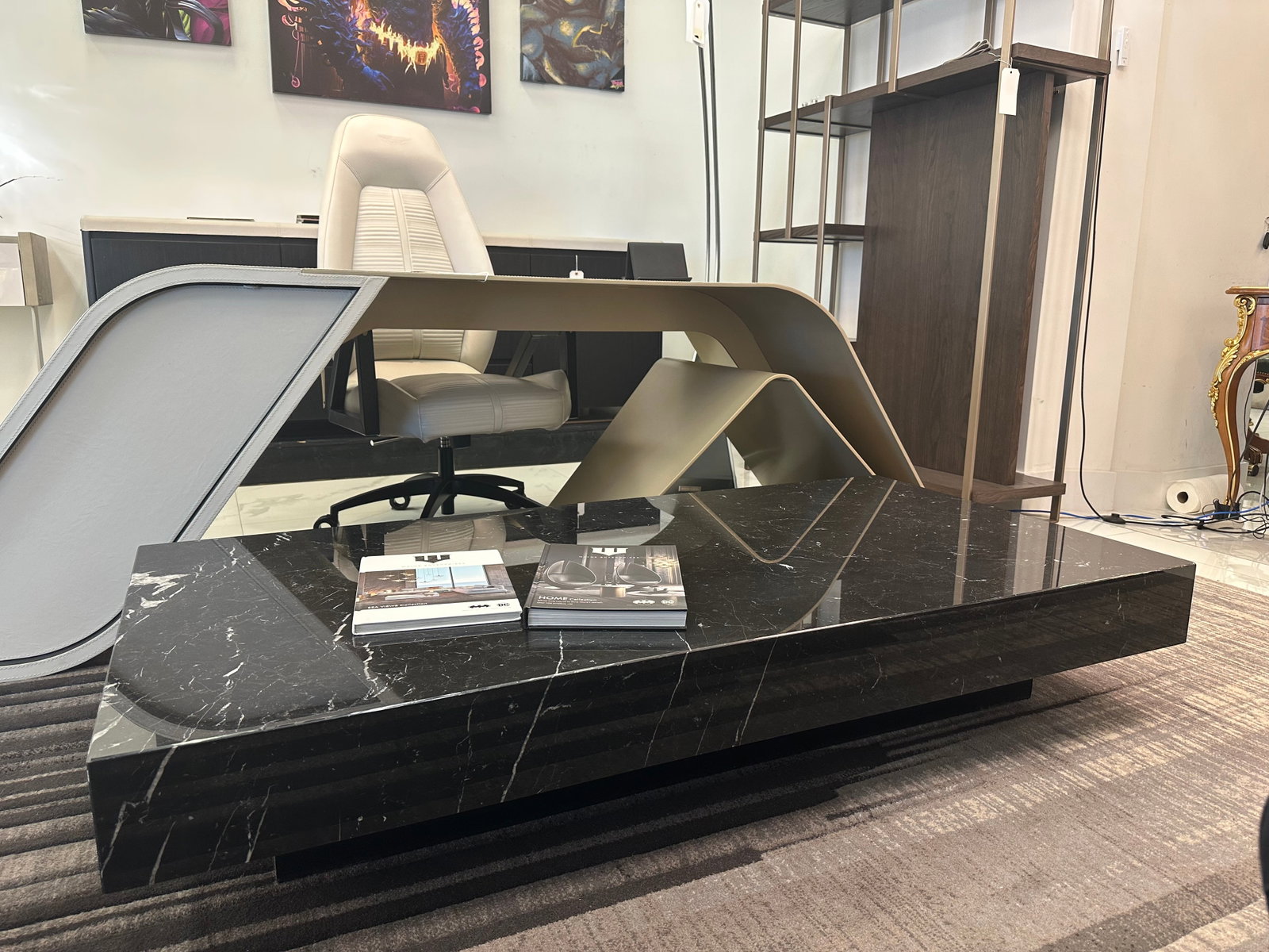 Wayne Enterprises Home Coffee Table: Enhance the decor of your house with the Wayne Enterprises' Coffee Table. Made of a marble top above a black finished base.32"W x 63"D x 12"H