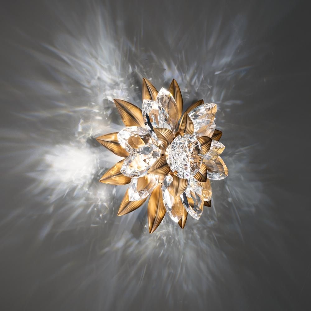 FOREVER SCHONBEK RHAPSODIE 14'' WALL SCONCE: The gorgeous light fixture has a cut crystal core surrounded by faceted petals composed of aged brass and optic crystal. Anyone who sees it will be captivated, challenged, and curious by its opulent d