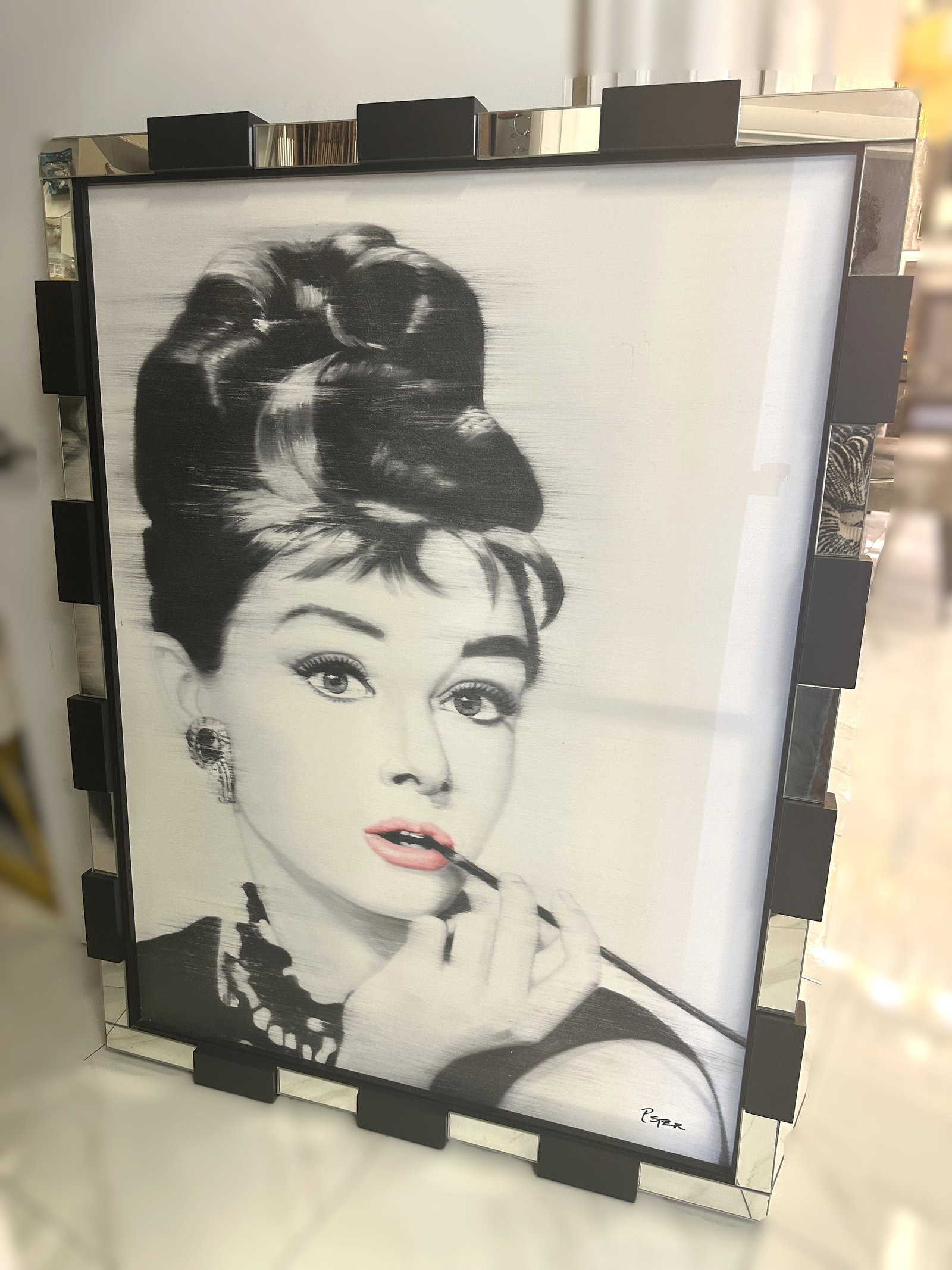 Audrey Hepburn Art: Monotone art of Audrey Hepburn in a modern mirrored glass frame.