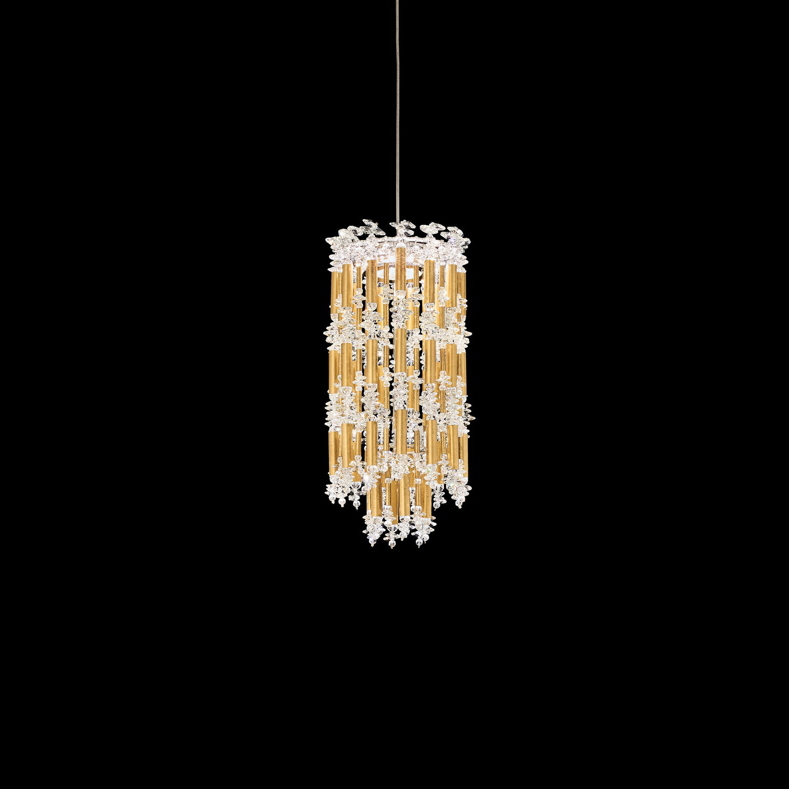 Schonbek Tahitian 7'' Mini Pendant In Heirloom Gold and Clear Optic Crystal: Channeling the serenity of verdant bamboo forests, Tahitian juxtaposes layers of organic Optic Crystal clusters with melodic vertical chimes to create profound movement. This chic modern Schonbek